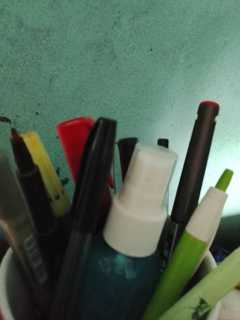 Assorted Pens, Markers, and Spray Bottle in Holder